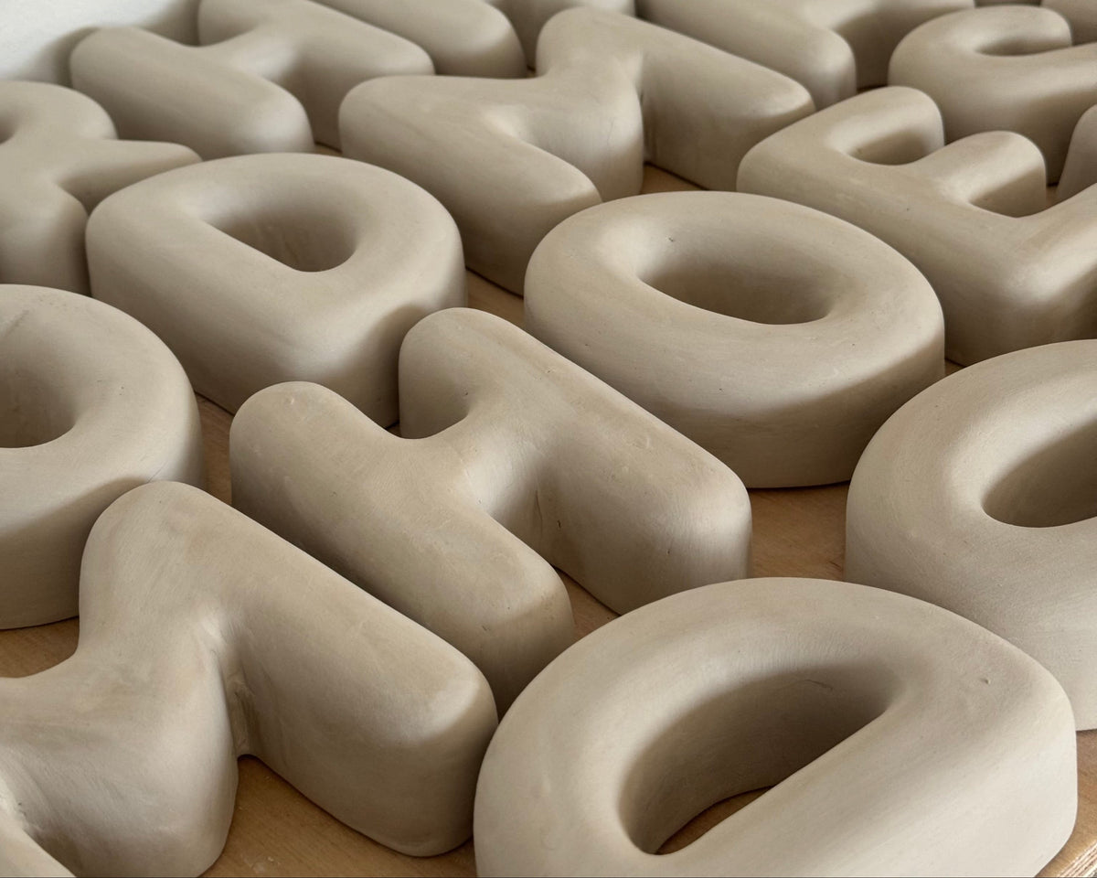 Clay-like letters on a wooden surface