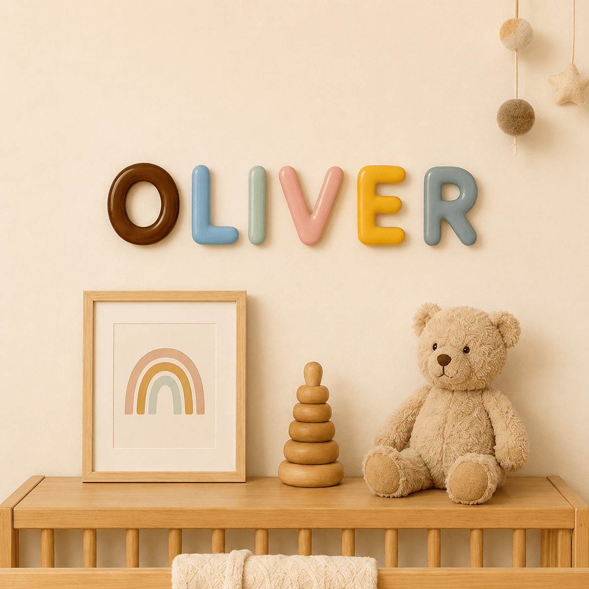 Ceramic name letters spelling Oliver above a nursery shelf – one of the baptism gift ideas that stays on the wall for years