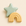 Green star and yellow rainbow-shaped ceramic objects on a beige background