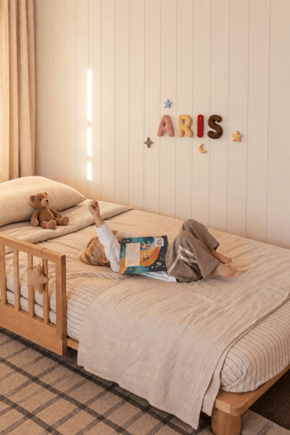 Handcrafted ceramic letters and symbols styled above a child&